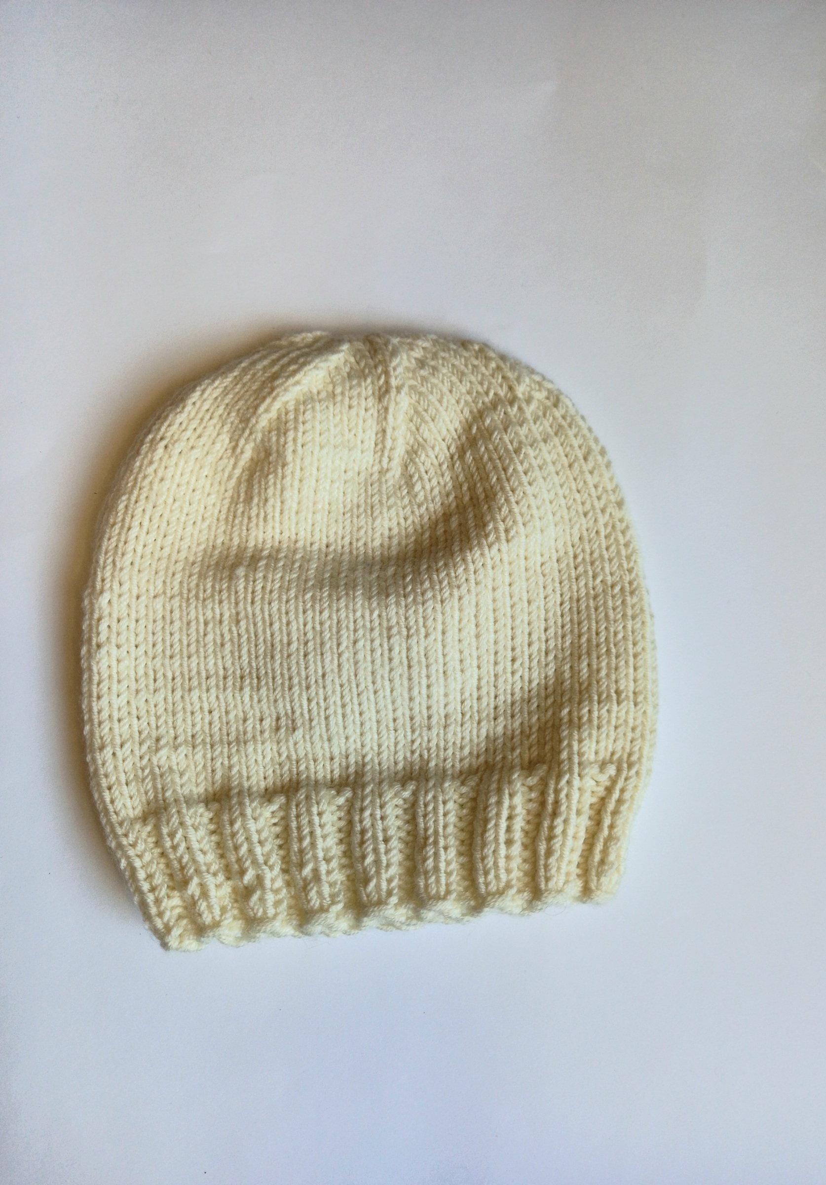 Rankų darbo megzta merino vilnos kepurytė naujagimiui 0 - 3mėn